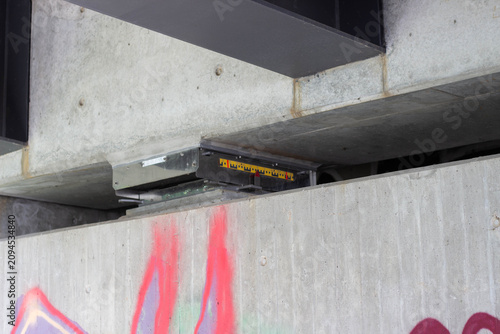 фотографія Industrial concrete structure with a mounted measuring device positioned above a