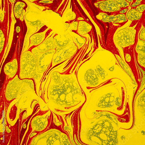 Ebru A Vibrant Abstract of Red and Yellow Swirls with Green Accents: An Intricately Designed Fluid Surface Exhibiting Dynamic Movement and Color Fusion