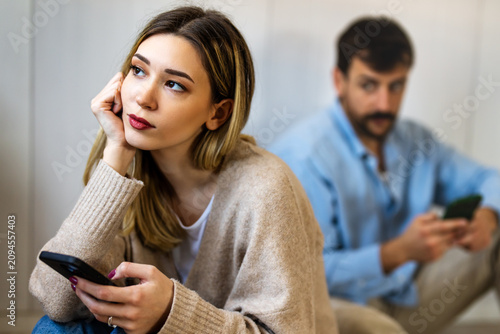 Gadget addiction and relationship problems. Couple with smartphones ignoring each other