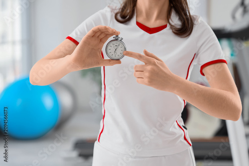 Woman in athletic wear hold...