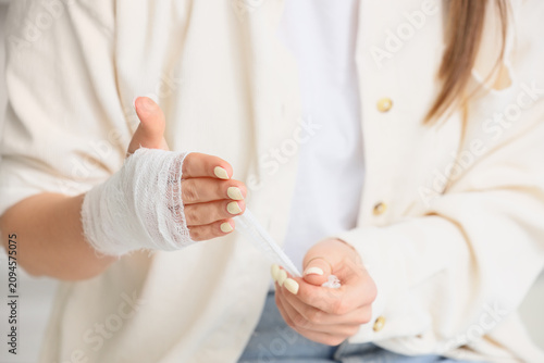 Womans bandaged hand with a...