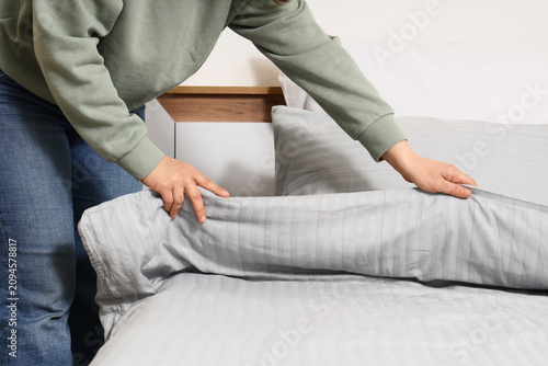 Person making a bed with fr...