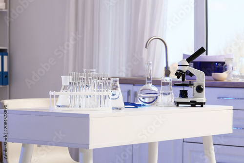 Scientists desk with microscope and water samples in laboratory
