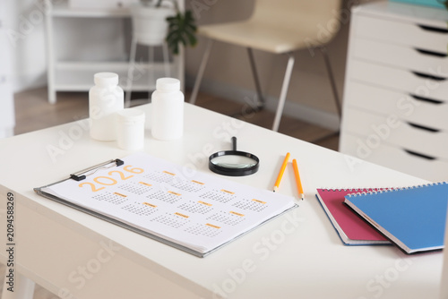 Calendar with pills, magnif...