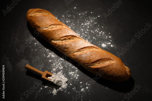 Fresh baguette and wooden s...