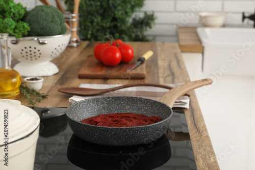 Frying pan with fresh tomat...