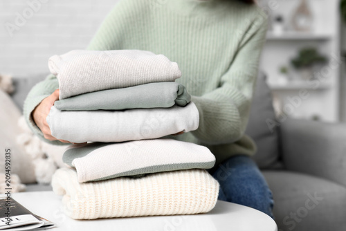 Young woman with stack of w...