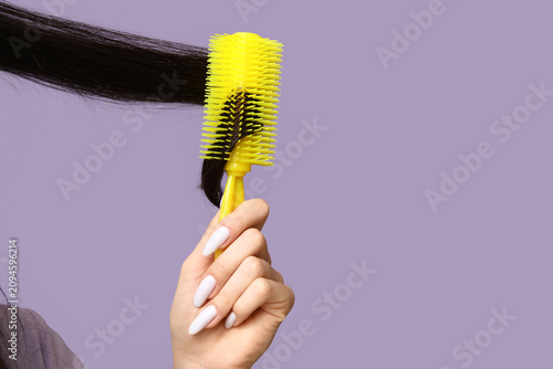 Young woman brushing her ha...