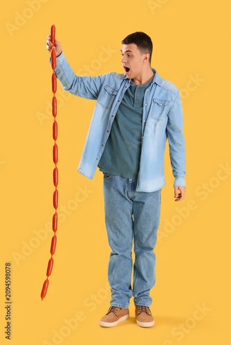 Surprised young man with ta...