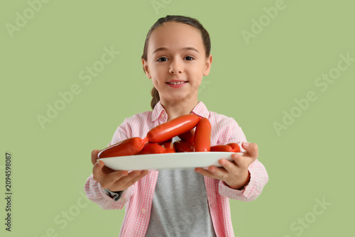 Little girl with plate of t...