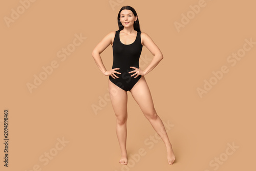 Body positive woman on beig...