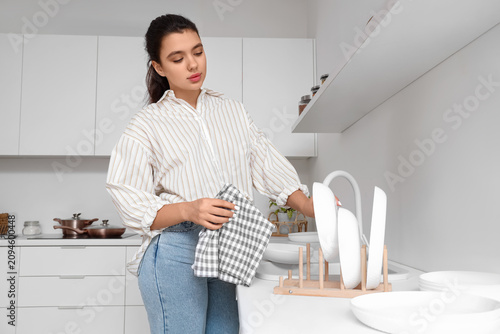 Beautiful young woman wipin...