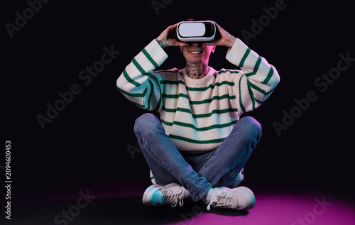 Young man using VR glasses ...