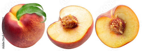 Whole and halved ripe peaches isolated on a white background