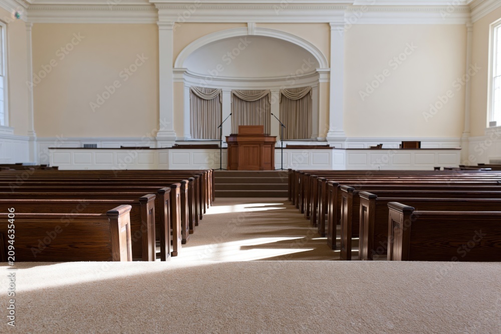 Obraz premium The Courtroom Interior with Empty Pews and Sunlit Central Podium