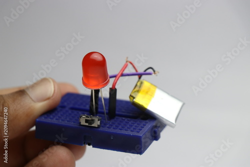 Small breadboard led circuit powered by lithium polymer battery and mini switch