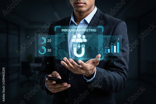 Businessman holding digital inbound marketing interface with magnet and data analytics