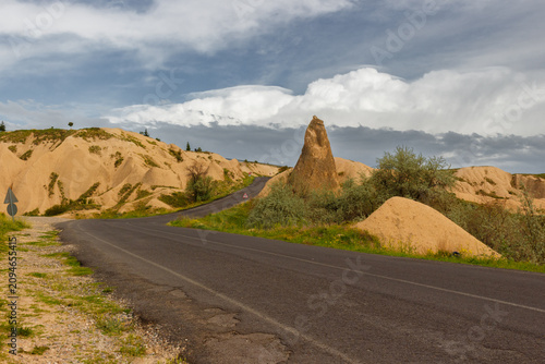 Empty road through the Devrent valley or Imagination Valley in Cappadocia, Turkey. The road passes through bizarre rock formations. Popular tourist attraction at excursion