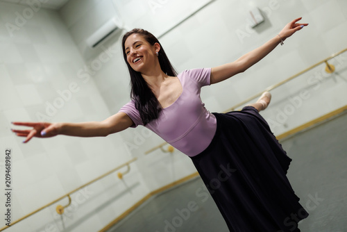 Bilde på lerret Dancer practices in a studio while wearing a pink top and black skirt during a d