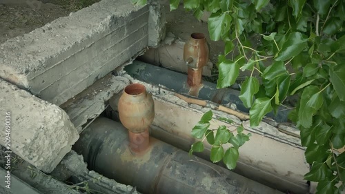 Industrial Decay: Corroded Pipes and Weathered Infrastructure in Underground Tunnel
