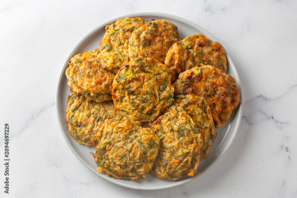 Naklejka premium Baked Turkish zucchini fritters known as mucver served on a ceramic plate