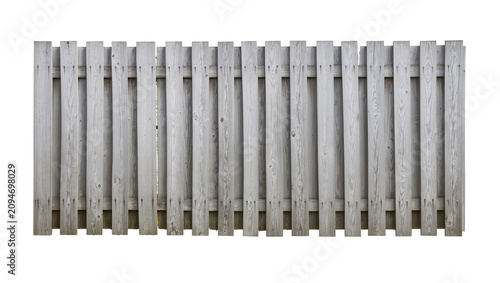 Isolated old weathered wooden picket fence structure, rustic gray timber wall section
