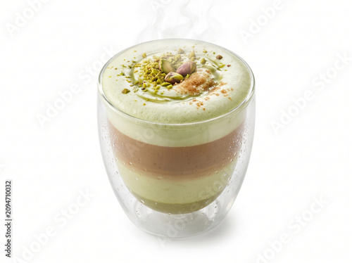 Delicious Pistachio Layered Coffee Latte in Clear Double Wall Glass Cup Premium Hot Espresso Drink Topped with Creamy Green Foam Crushed Nut Toppings Isolated on White Background Culinary Beverage