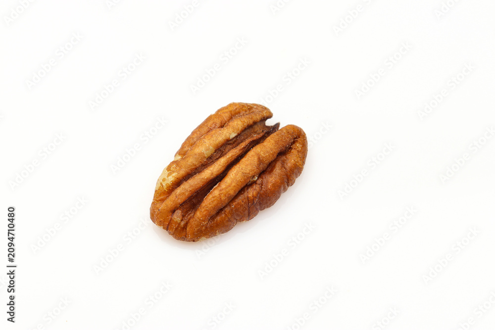 Fototapeta premium Single piece of pecan nut isolated on white background