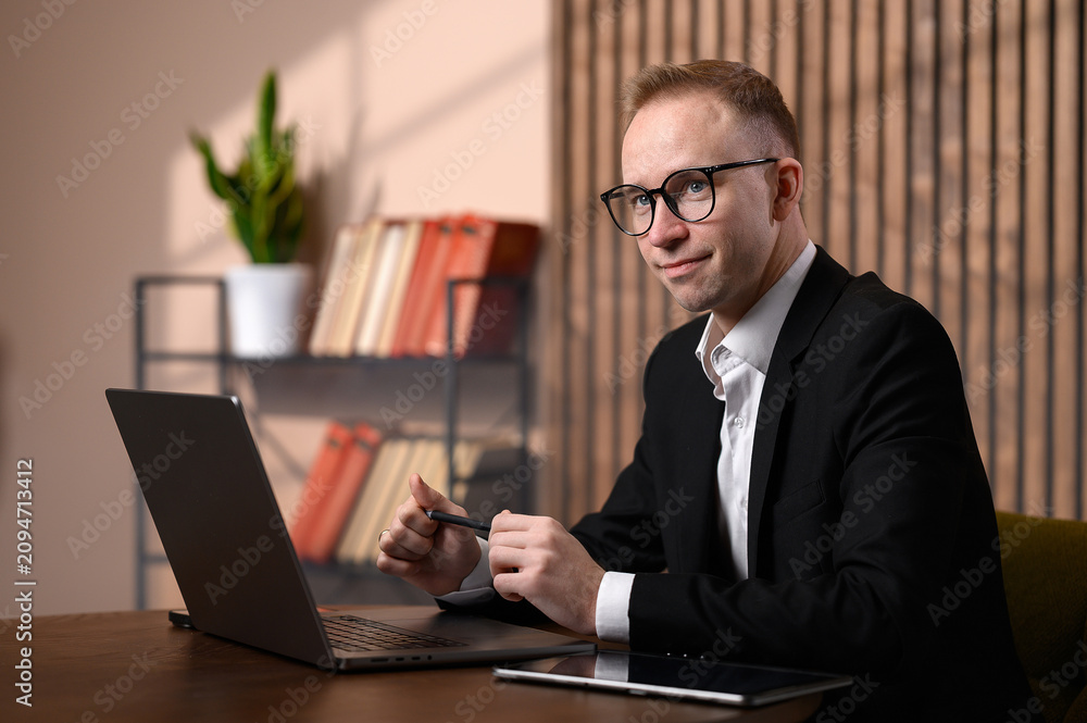 Fototapeta premium Confident Business Consultant Looking at Camera While Working at Laptop in Modern Office