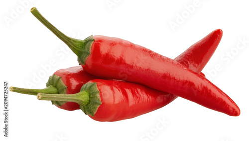 фотографія Isolated three vibrant red hot chili peppers, fresh and spicy cooking ingredient