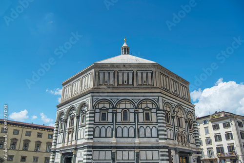 The landmark Baptistery of saint john on a blue sky sunny day in Florence italy