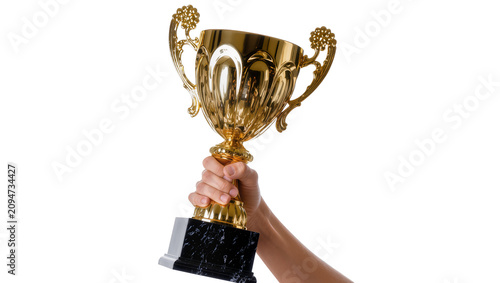 Konstfotografi Isolated hand holding shiny golden award trophy for victory and success in compe