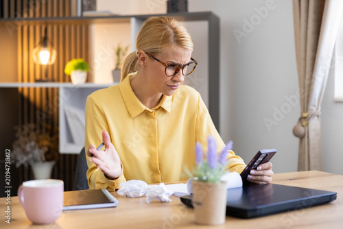Bild auf Leinwand Anxious woman feeling frustrated while working from home, reacting to bad news o