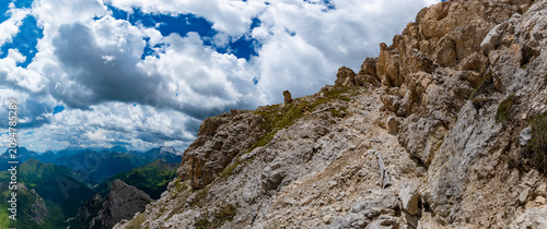 Bild auf Leinwand Low angle view of rugged limestone crags and steep rocky cliffs under a dramatic