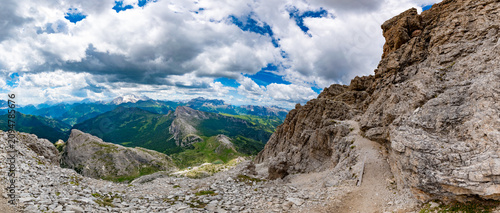 Canvastavla Extensive high altitude panorama of a narrow mountain trail along steep limeston