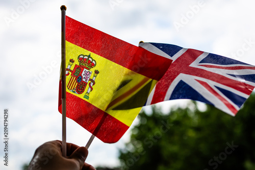 Fotografie Spain and the United Kingdom flags catch the light while waving in the breeze he