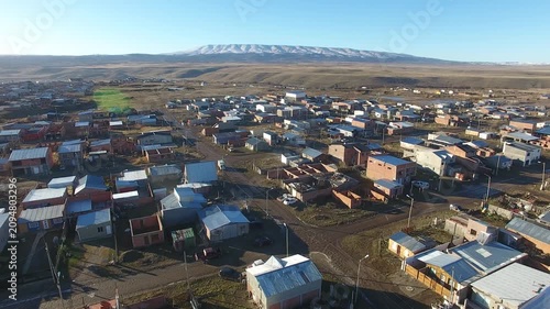 4K aerial drone footage flying over 28 de Noviembre, a Patagonian town in Santa Cruz, Argentina. Scenic mountain surroundings, residential neighborhoods, and the unique landscape of southern Patagonia