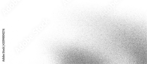 Abstract halftone background with black dots of varying sizes, creating a gradient effect, suitable for modern graphic design, print patterns, and digital textures