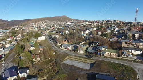 4K aerial drone footage flying over Río Turbio, a Patagonian mining town in Santa Cruz, Argentina. Scenic urban landscape surrounded by rugged mountains, showcasing the beauty of southern Patagonia.