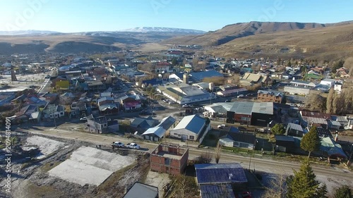 4K aerial drone footage flying over Río Turbio, a Patagonian mining town in Santa Cruz, Argentina. Scenic urban landscape surrounded by rugged mountains, showcasing the beauty of southern Patagonia.