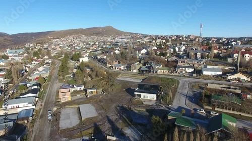 4K aerial drone footage flying over Río Turbio, a Patagonian mining town in Santa Cruz, Argentina. Scenic urban landscape surrounded by rugged mountains, showcasing the beauty of southern Patagonia.
