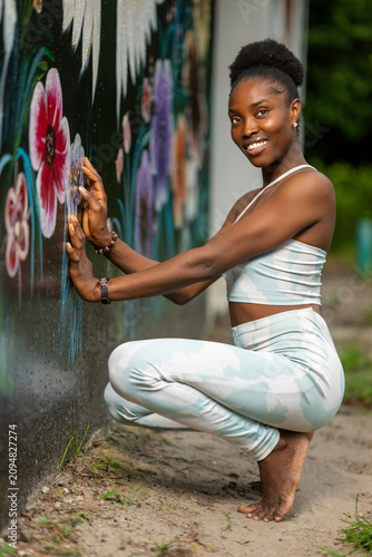 Portrait of a young African woman doing a squat