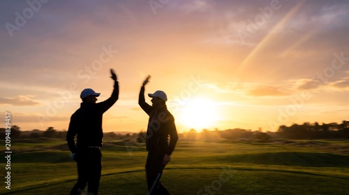 golfers celebrate on sunset links course