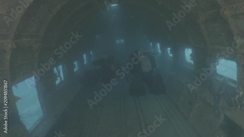log footage of an airplane wreck underwater scuba divers to explore  metal on ocean floor