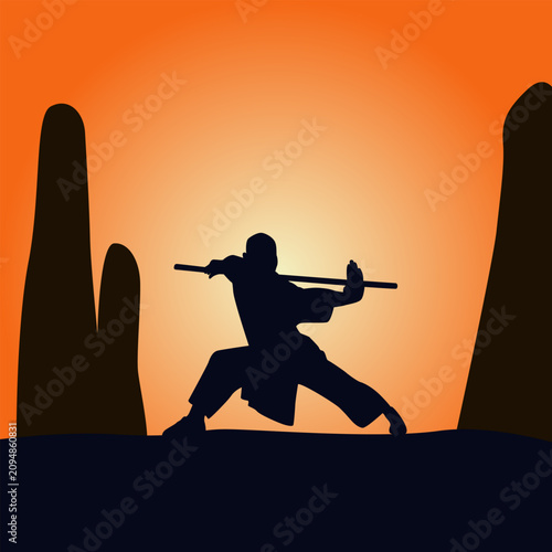 Silhouette of a monk practicing wushu movements using a stick on a mountain, kungfu silhouette