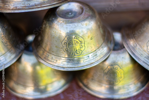 Tableau sur toile Buddhist ritual brass bowls with sacred engravings in Ladakh