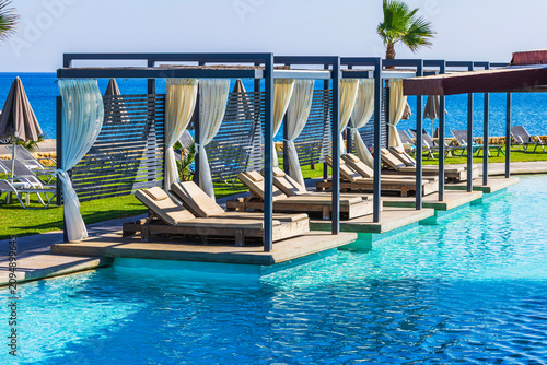 Close up view of luxury pool cabanas at hotel overlooking Cretan Sea. Greece. Crete. 