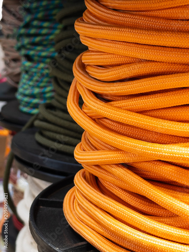 Fotografie Colorful braided ropes and utility cords on spools in hardware store