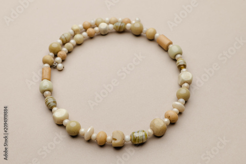 Obraz na płótnie Elegant Handmade Bead Necklace on a Neutral Background, Featuring a Variety of E