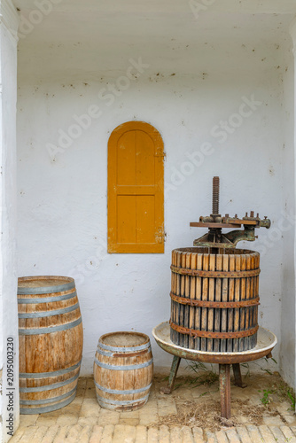 Tablou pe pânză Old grape press and wine barrels in Palkonya cellar